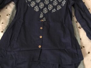 Navy blue printed blouse and gray trousers