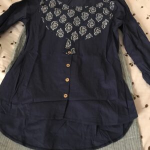Navy blue printed blouse and gray trousers