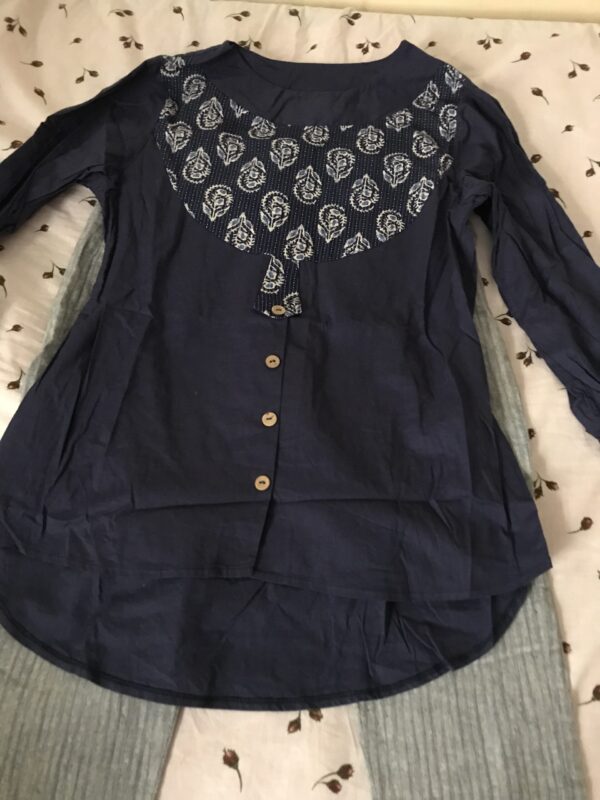 Navy blue printed blouse and gray trousers
